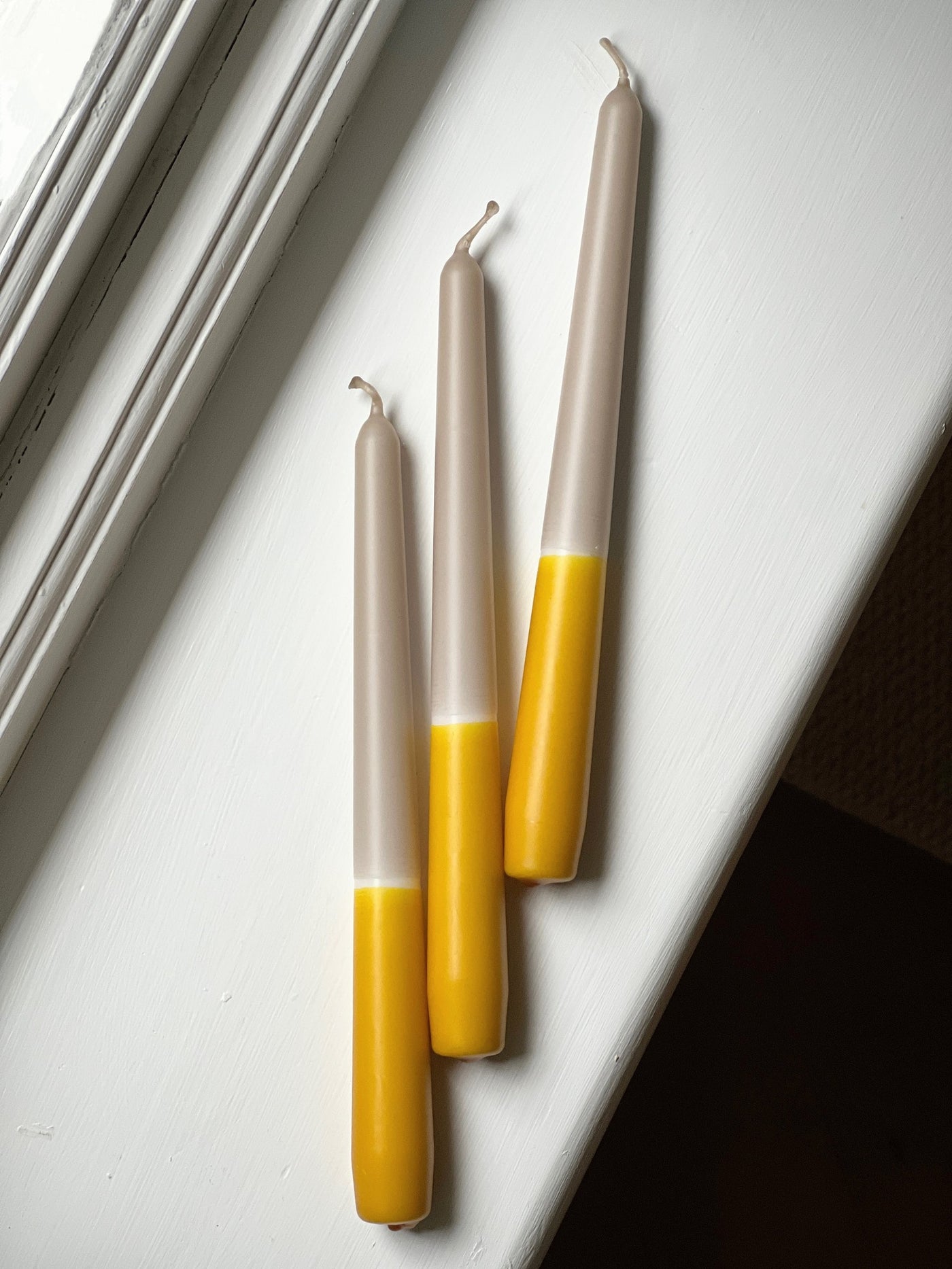 Ochre yellow dip dye tapered candle trio. Made in England by Loriest & Co. Perfect for every room and any style.