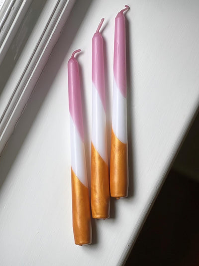 Dip dye taper candles in rose pink and warm gold. Made in England.