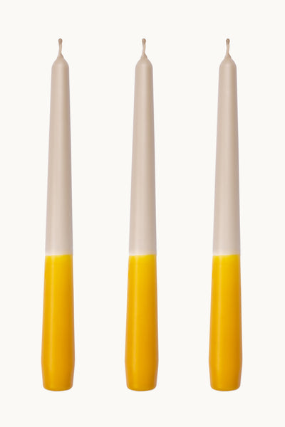Sunny yellow taper candles. A trio of ochre yellow dip dye taper candles, made in the UK.