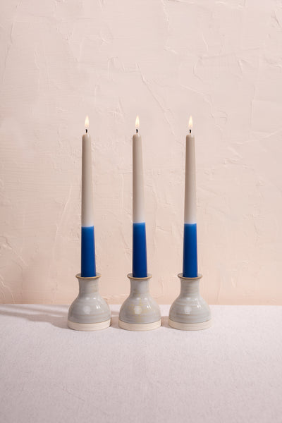 Navy blue dip dyed dinner candle trio. Colourful tapered candles made in England.